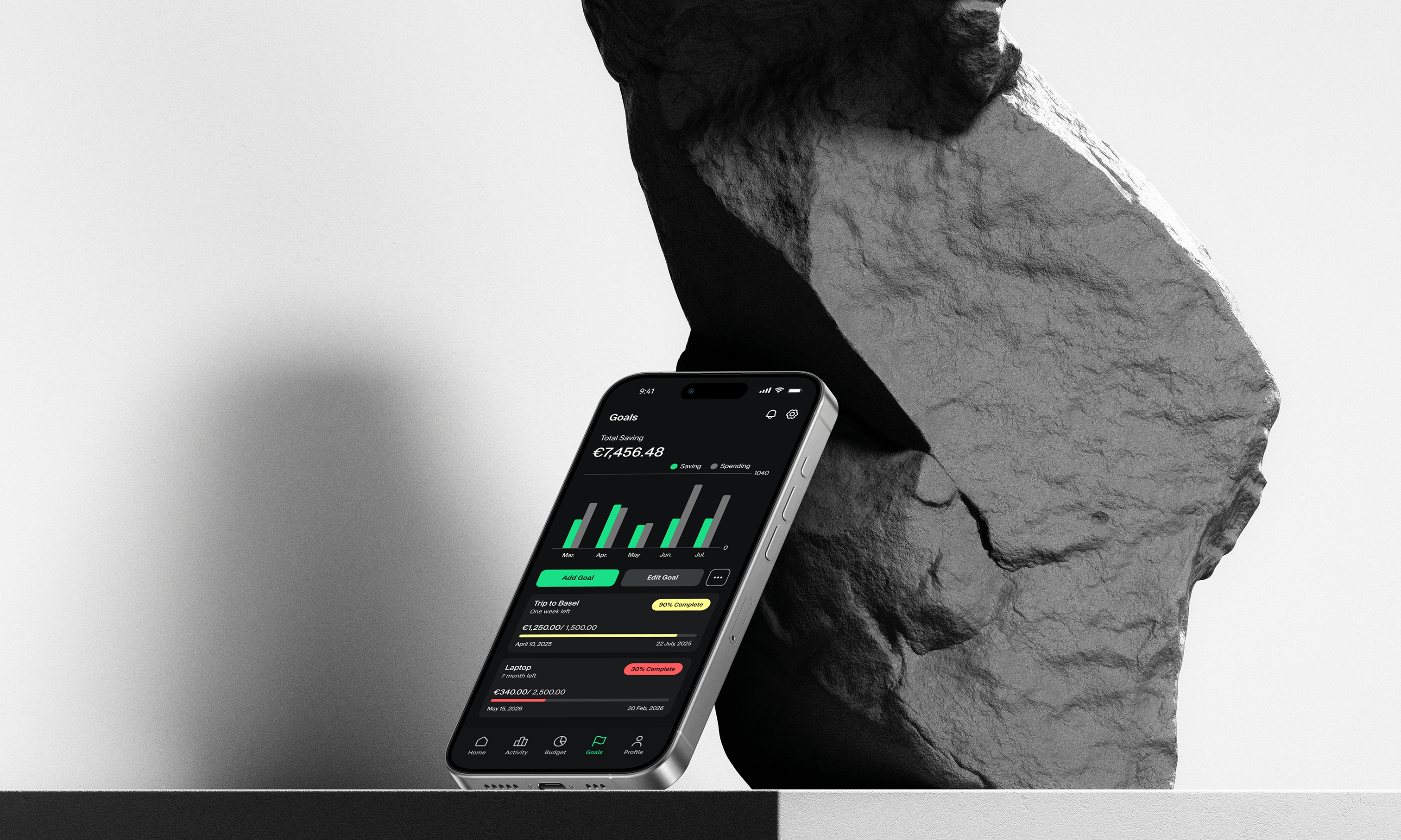 Grava Goals screen on a phone resting against a sculpture