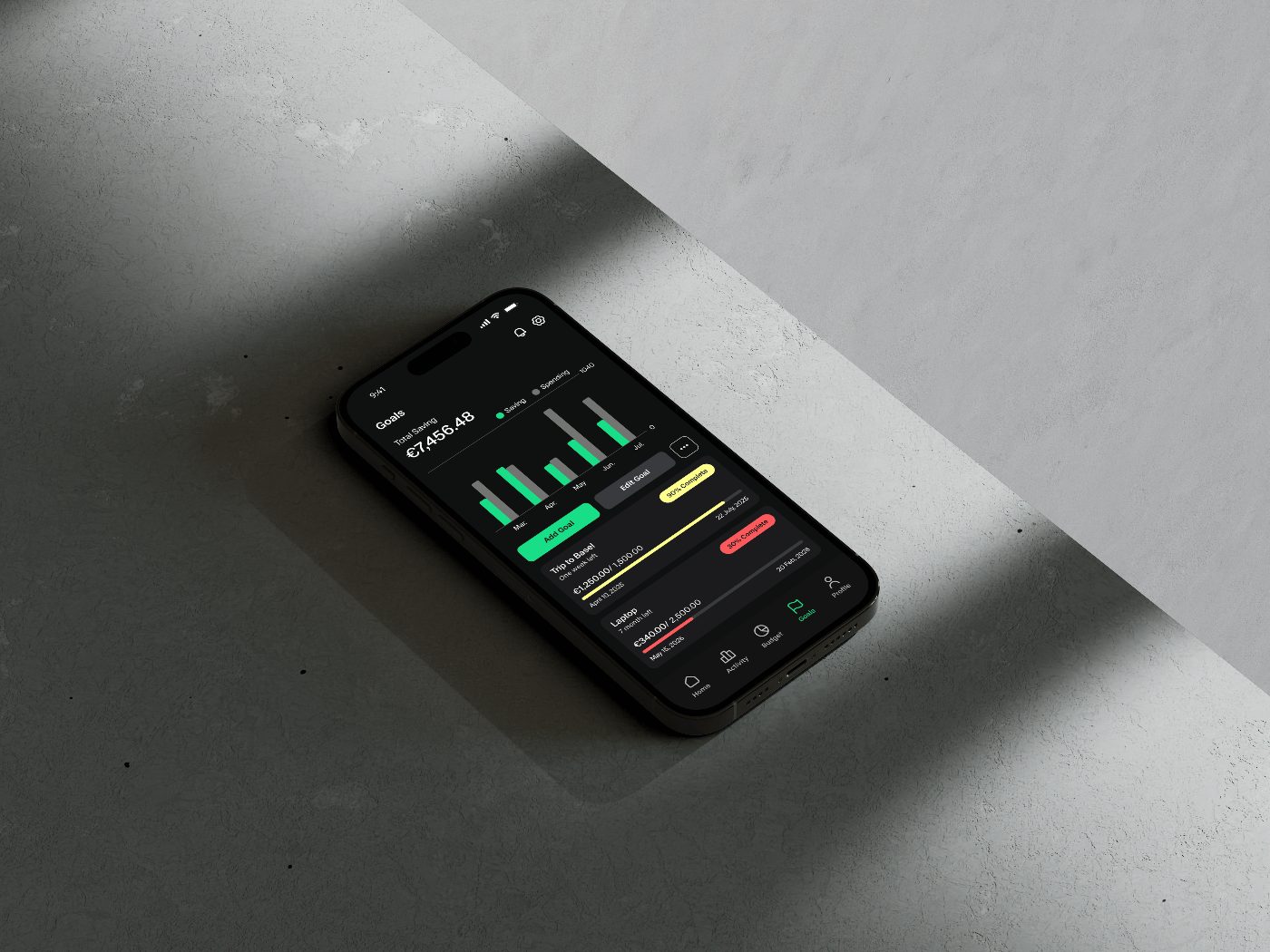 Grava Goals screen on a phone lying on a sunlit concrete surface