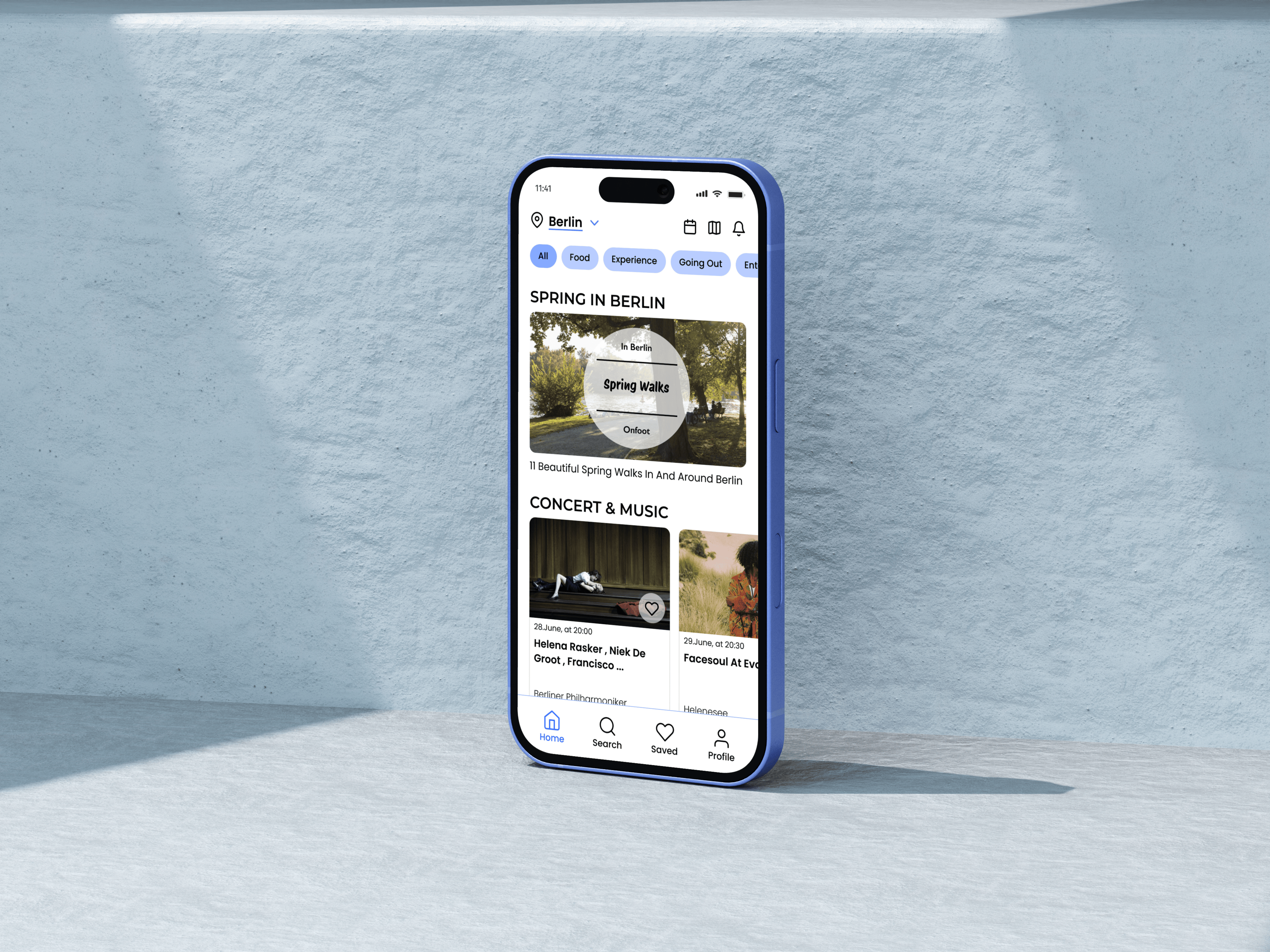 Onfoot home screen on a phone standing against a pale-blue plaster wall